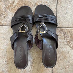 Brown sandal slides with gold tone detail.